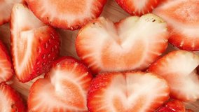 A mesmerizing macro video showcases a half strawberry in exquisite detail. Shot with a probe lens, it reveals the intricate textures, vibrant colors, and tantalizing juiciness of this luscious fruit.
