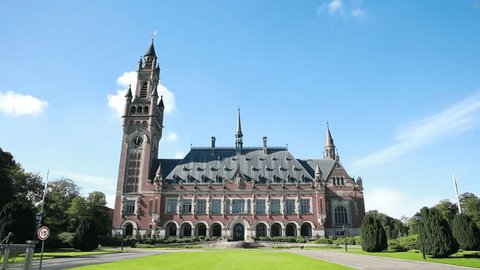 The Hague, Netherlands - September 29 2022 : The exterior of the almost castle like Peace Palace in his gardens . In use by the International Court of Justice of the United Nations. Adlı Haber Amaçlı Stok Video