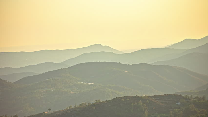 View of a misty orange sky over Mount Olympus on the island of Cyprus.