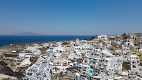 Revealing drone shot of the city Oia on the Greek island of Santorini