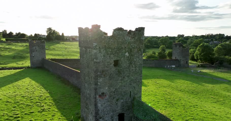 Medieval defence wall with tower against a green field 4k