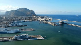 Aerial shot drone flies to right over cruise port in Palermo, Sicily, Italy with Mount Pellegrino in the distance