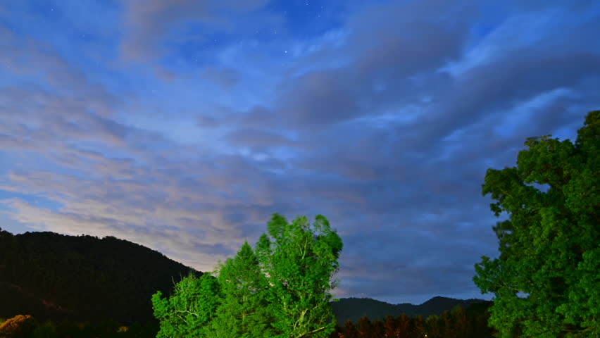 Rising stars (with brief passing of Milky Way) and passing clouds, time lapse, over mountains of the Great Smoky Mountains National Park, Townsend, Tennessee, US.