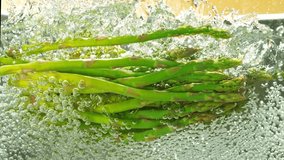 Super Slow Motion of Falling Asparagus Into Boiling Water. Concept of Vegetable Broth Inside Stainless Steel Pot. Filmed on High Speed Cinema Camera, 1000 fps. - Powered by Shutterstock - Get 15% off with code: PIKWIZARD15