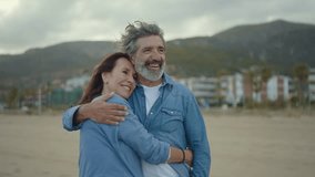 Cinematic video of a senior couple spending time on the beach and making different activities near the ocean. Romantic concept about a man and a woman in love. Lifestyle in the seniority age