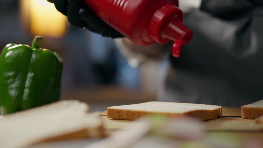 Fast food, Fry Cook strongly adding red tomato sauce to a specialty diner. camera in motion experienced cook works at the workplace of the cook Cooking sandwiches with protein-free meat, calories
 Royalty-Free Stock Footage #1106215465