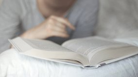 the girl lies on the bed and reads a book on psychology. Leisure hobby, literature training - Powered by Shutterstock - Get 15% off with code: PIKWIZARD15