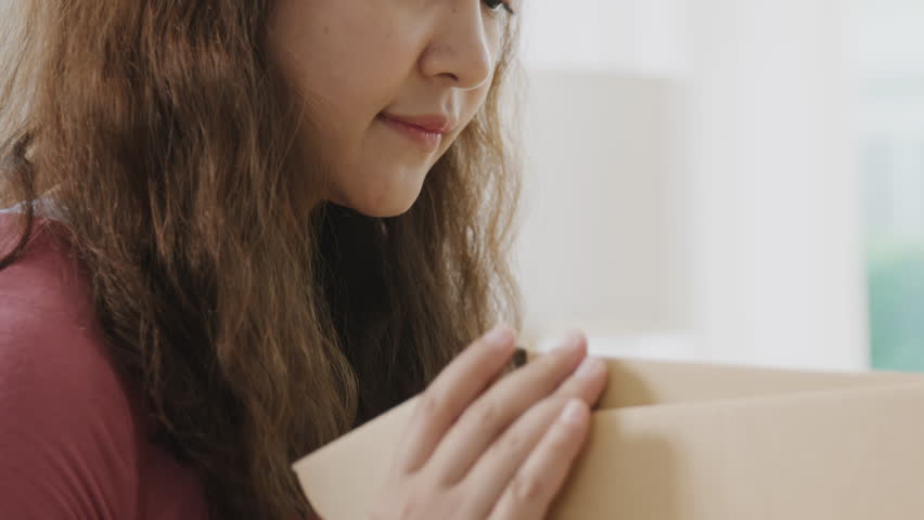 Asia people young Gen Z woman smile open unbox unpack parcel box goods carton packaging happy joy face. Omni channel enjoy buy gift order postal at retail online shop store send courier home service. | Shutterstock HD Video #1106223109