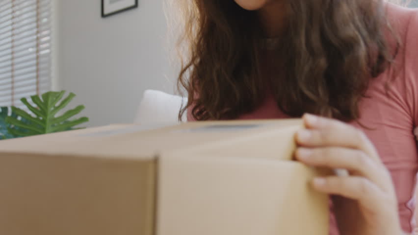 Asia people young Gen Z woman smile open unbox unpack parcel box goods carton packaging happy joy face. Omni channel enjoy buy gift order postal at retail online shop store send courier home service. | Shutterstock HD Video #1106223115