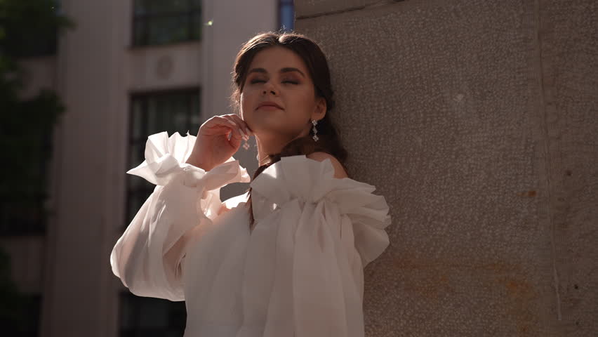 Bride leaning against the wall