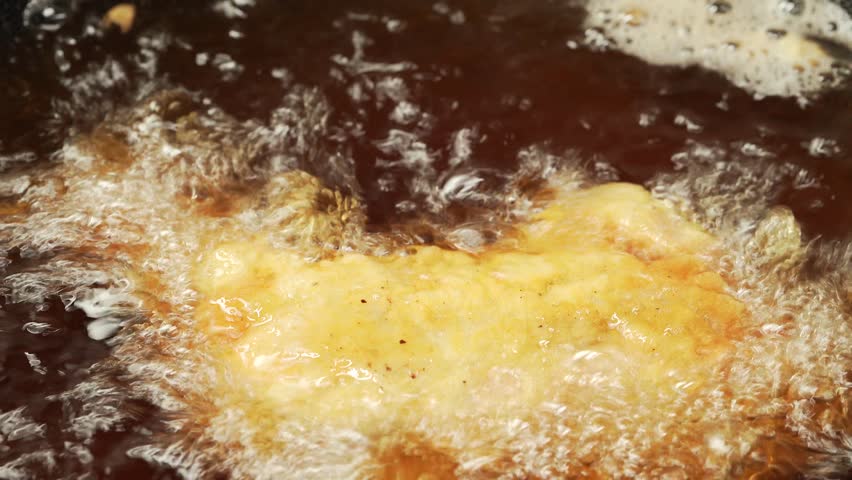 Deep fried fresh chicken thighs Royalty-Free Stock Footage #1106224331