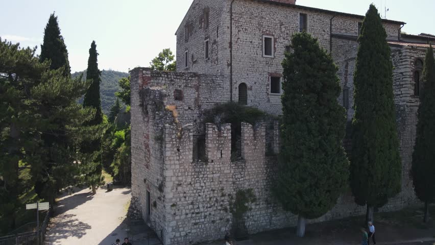 Medieval castle in the middle of the city of Brescia in Italy. Beautiful panorama of the whole city from above. High walls with towers and large gardens.