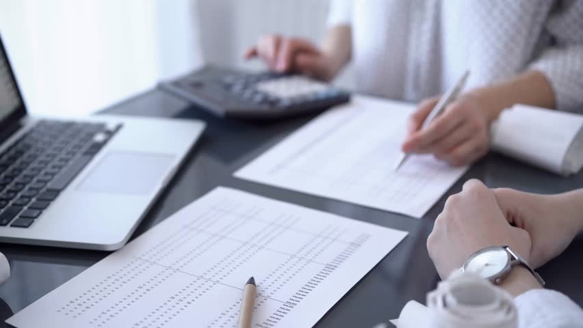 Female accountant counting taxes or making revenue balance for a client. Business audit and finance concepts Royalty-Free Stock Footage #1106232809