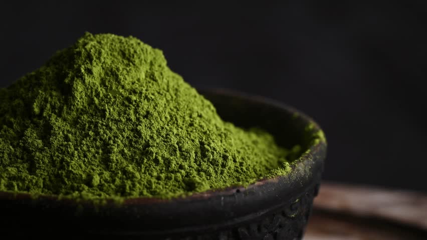 Matcha green tea powder rotating close up view