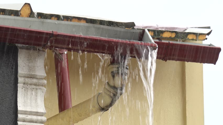 Rain streams flow down from clogged drain pipe along house wall  Royalty-Free Stock Footage #1106236423