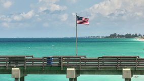 Aerial seascape with Venice fishing pier and sandy beach in Venice, USA. Many tourists enjoing summer vacation time swimming in warm Mexico gulf water and sunbathing on hot Florida sun - Powered by Shutterstock - Get 15% off with code: PIKWIZARD15