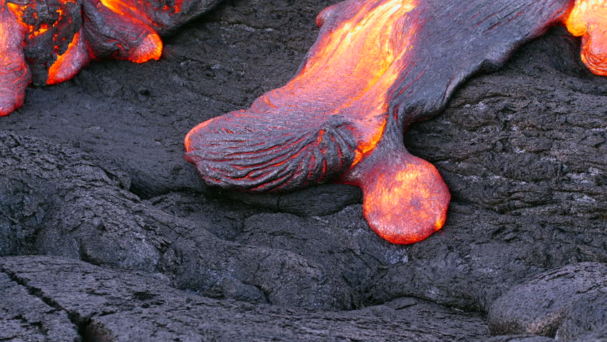 Surface flow lava oozes out of the nooks and crannies dried lava during an eruption from Kilauea volcano. Royalty-Free Stock Footage #1106245593