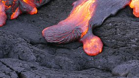 Surface flow lava oozes out of the nooks and crannies dried lava during an eruption from Kilauea volcano. - Powered by Shutterstock - Get 15% off with code: PIKWIZARD15