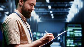 Supervisor monitoring energy efficient servers using renewable sources to minimize consumption and reduce overall facility carbon footprint. Technician working in eco friendly data center - Powered by Shutterstock - Get 15% off with code: PIKWIZARD15