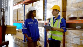 Smiling workers in distribution warehouse having a cheerful conversation. They wearing vest and safety helmet in work - Powered by Shutterstock - Get 15% off with code: PIKWIZARD15