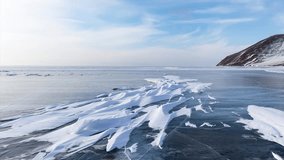 Video of Baikal Lake in winter cold day. Unusual landscape with blue iced bay and white snow crusts in form of frozen waves. Beautiful winter background