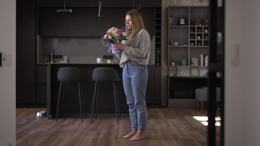 Wide shot furious angry young woman breaking bouquet of flowers and looking at camera with desperate facial expression. Portrait of hopeless frustrated Caucasian lady posing after breakup Royalty-Free Stock Footage #1106262583