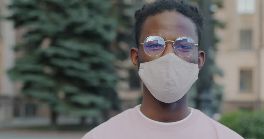 Slow motion portrait of healthy African American person wearing face mask during covid-19 global pandemic. People and infection outbreak concept. Royalty-Free Stock Footage #1106264855
