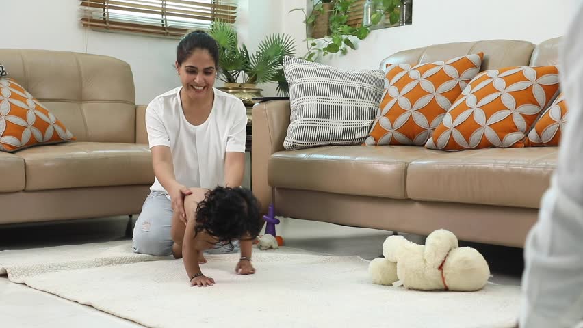 Indian parents are happily watching their baby crawl.
 Royalty-Free Stock Footage #1106268975