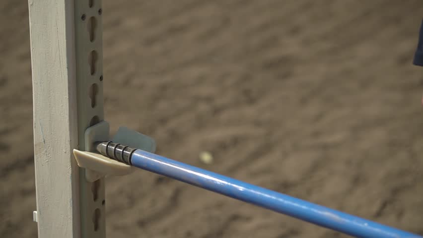 Horseback riding. close-up obstacles for jumping. teenagers jump over obstacles. girl teenager lift the barbell on an obstacle. slow motion video. Full HD video recording