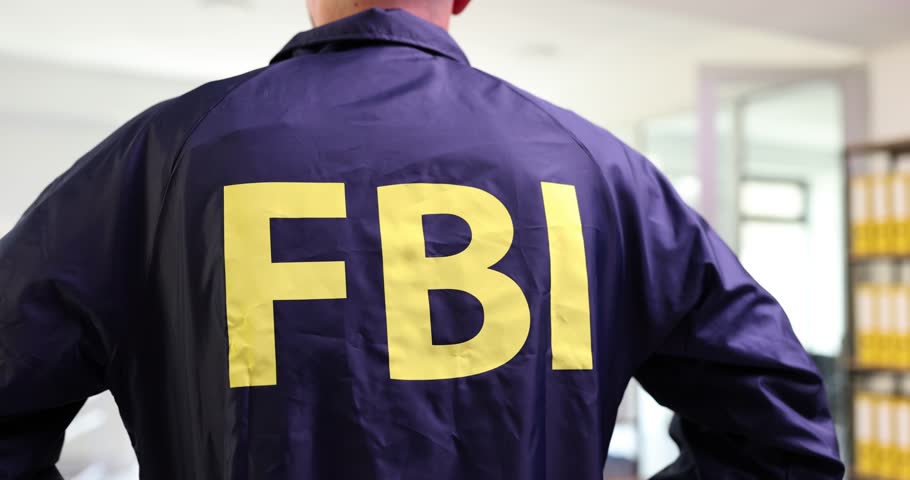 FBI agent in FBI uniform stands with back Royalty-Free Stock Footage #1106277905