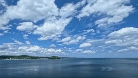 Beautiful clouds flowing against the blue sea and sky. Time lapse video shot in Minamisanriku.