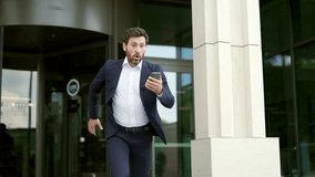 Man rushes to work. Late business meeting. Worried businessman on the way to office. Male in suit in hurry running Deadline. Time management. Busy Lifestyle rush and looks at the smartphone - Powered by Shutterstock - Get 15% off with code: PIKWIZARD15