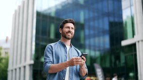 Handsome happy bearded businessman in casual walking near modern business office building hold smartphone in hands. Matureadult Man entrepreneur seo manager using read a mobile phone outside lifestyle - Powered by Shutterstock - Get 15% off with code: PIKWIZARD15