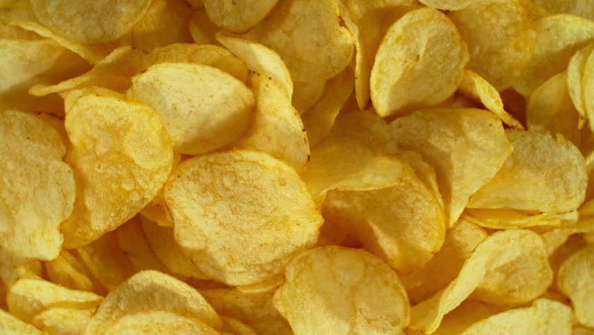 Super slow motion of flying fried potatoes chips on color gradient background. Filmed on high speed cinema camera, 1000 fps. Camera placed on high speed cine bot, tracking the target. Royalty-Free Stock Footage #1106283405