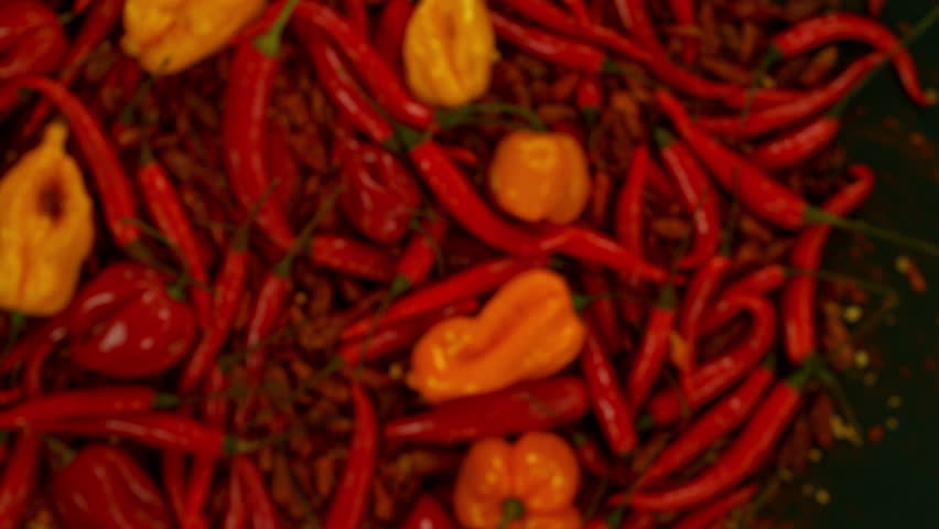 Super Slow Motion Shot of Flying Fresh Chilli Peppers Isolated on Black Background at 1000 fps. Royalty-Free Stock Footage #1106283439