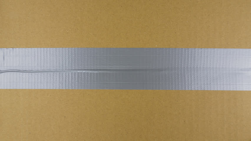 Unpacking carton box with chromakey inside. Hand tears off adhesive tape from a cardboard box, view from the top Royalty-Free Stock Footage #1106284279