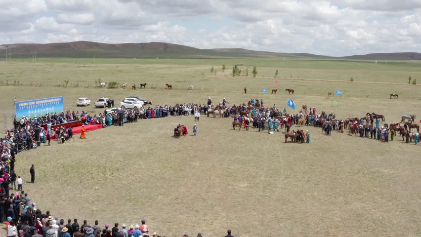 Wheel of people at the traditional festival in Naadam, Mongolia. Aerial dolly out