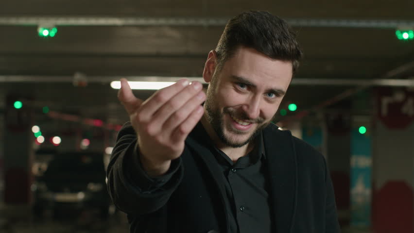 Caucasian smiling man point finger at camera choose you follow me gesture inviting to join happy male guy businessman driver in car parking invite asking to come here calling welcome beckoning appeal