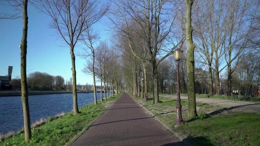 Empty walkway at Riverside public Park, Amsterdam, slow motion, March 2021
