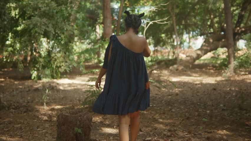 Girl wandering walks in sunny forest. Woman hiking solo. Teenager lady hike trail, hazy sunny day. people in park in forest. Active lifestyle. People in woods Tourist walk in summer, cinematic