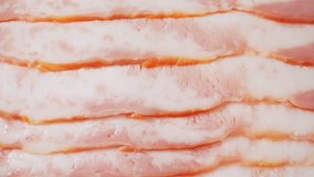Delve into the captivating world of uncooked bacon with a macro lens. Marvel at the delicate striations and vibrant colors, offering a sensory experience that will leave you craving more. 4K HDR

