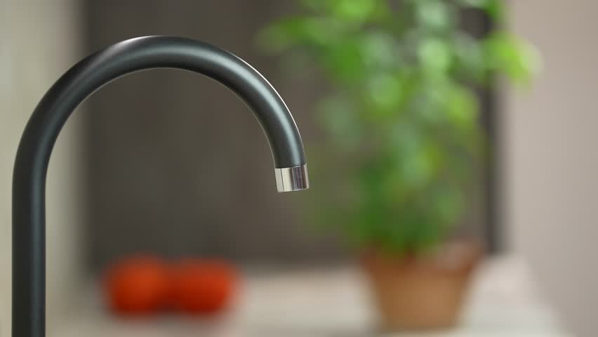 A jet of water runs from a water pipe. Turning off, close faucet tap in kitchen. clean drinking water. Drop of water drips from the tap Royalty-Free Stock Footage #1106305729