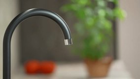 A jet of water runs from a water pipe. Turning off, close faucet tap in kitchen. clean drinking water. Drop of water drips from the tap - Powered by Shutterstock - Get 15% off with code: PIKWIZARD15