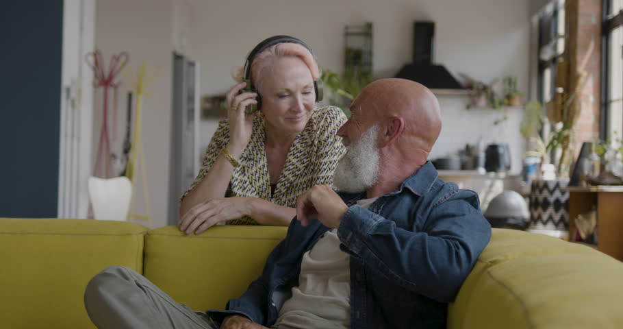 Senior Adult Couple Listening to Music using Smart phone on Sofa at Home Royalty-Free Stock Footage #1106309741