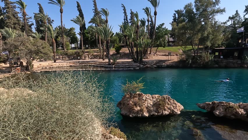 the nature reserve and national park Gan Hasholsha in the Valley of the Springs in the north of Israel. Clear turquoise water on a background of green vegetation and trees