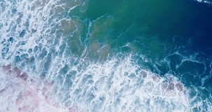 4K DCI Coastal Phuket Thailand, as monsoon storms surpass high waves, top-down view aerial video, huge sea waves rolling into sandy beach at Andaman coast, filmed on high quality cinema cameras.