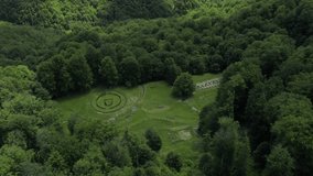 4k aerial time lapse video over Sarmizegetusa Regia landmark in Romania with clouds moving over it. Amazing old fortress in Orastiei Mountains surounded by green forest.