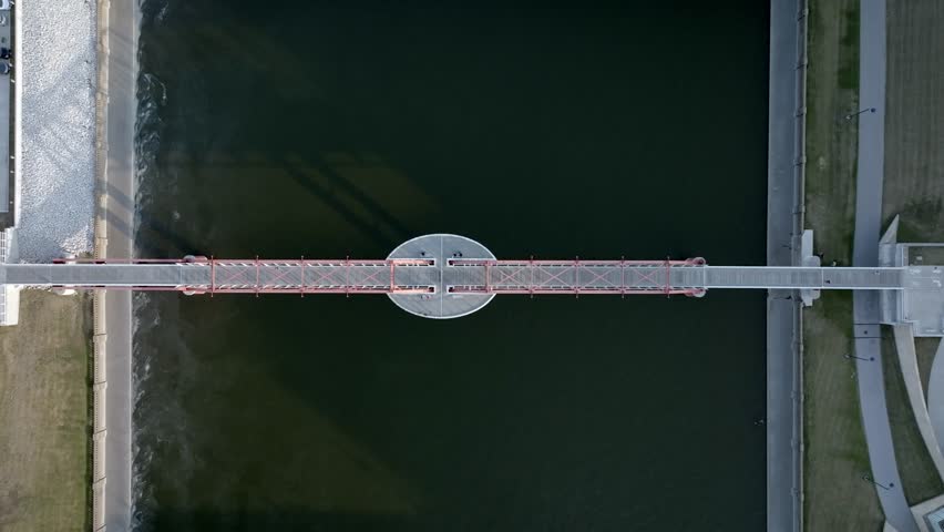 Pedestrian bridge over Des Moines River in downtown Des Monies, Iowa with drone video overhead and moving down.