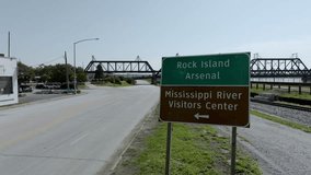 Rock Island Arsenal sign and Mississippi River Visitors Center sign in Davenport, Iowa with drone video stable.