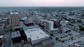 Downtown Davenport, Iowa with drone video moving right to left at dusk wide shot.